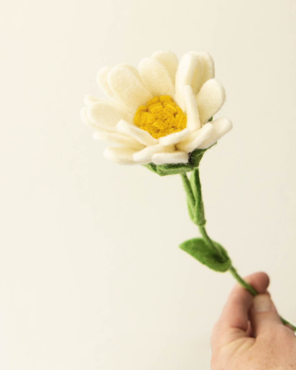 Close-up of white felt daisy petals and yellow centre